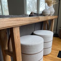 two stools under a wooden table in a living room