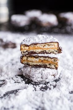 three cookies stacked on top of each other covered in powdered sugar