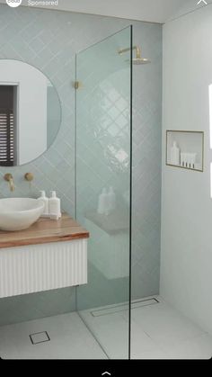 a bathroom with a sink, mirror and stand up shower stall in the middle of it