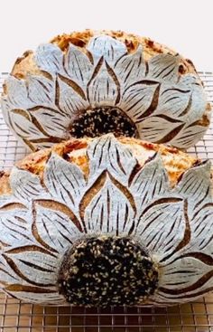 two bundt cakes sitting on top of a cooling rack