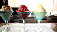 three martini glasses filled with ice cream and strawberries