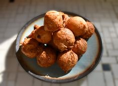 a plate full of fried food sitting on top of a white and blue tile floor