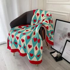 a chair with a blanket draped over it next to a framed photo and other items