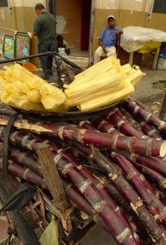 there are many large pieces of food on the street cart that is loaded with bananas