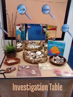 the table is set up with books and other items for an interesting event or gathering