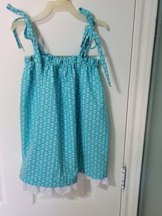 Super comfy teal color Sun Dress with white anchors, shoulder ties, elastic around the chest area and trimmed at the bottom with beautiful white eyelet lace. Will fit a little girl who wears a size 2 or 3.  Fabric has been pre-shrunk.  Free shipping. Beach Sundress With Cotton Lace Trim, Cotton Sundress With Lace Trim For Beach, Cute Sleeveless Sundress With Lace Trim, Green Cotton Sundress With Tie Back, Cotton Sundress With Lace Trim, Cotton Lace Trim Sundress, White Eyelet, Teal Color, Eyelet Lace