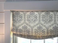 a window with a valance that has a flower pattern on it