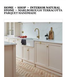 a kitchen with marble counter tops and gold faucets on shelving above the sink