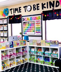 a classroom with lots of books and toys on the shelves in front of it that says time to be kinder