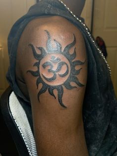 a man with a sun tattoo on his arm