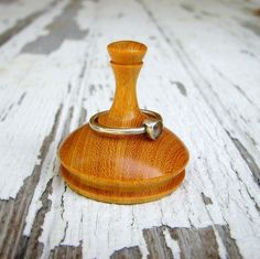 a wooden ring holder sitting on top of a table