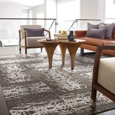 a living room with two couches, chairs and a coffee table in front of a window