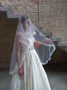 a woman in a white wedding dress and veil