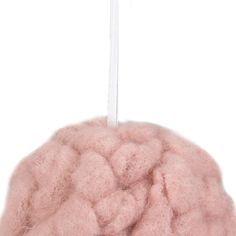 a pink ball ornament hanging from a white string on a white background,