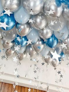 silver and blue balloons with stars hanging from the ceiling