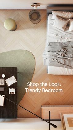 an aerial view of a bed and desk in a room with wood flooring on the walls