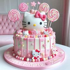 a hello kitty birthday cake with lollipops and candy