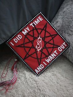 a red and black graduation cap that says i did my time and i want out