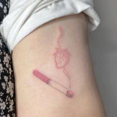 a woman's stomach with a small tattoo on the side of her leg and a pencil in it