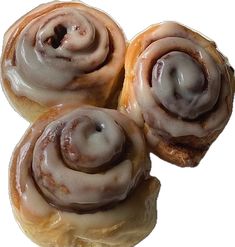 three glazed donuts sitting on top of each other next to each other with icing