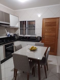 a kitchen with a table and chairs in it