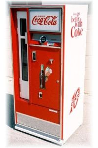 an old fashioned coca - cola machine is on display