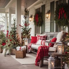 a porch decorated for christmas with red and white plaid pillows, wreaths and trees