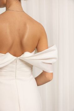 the back of a woman's white dress