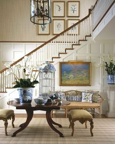 a dining room table with chairs under a stair case