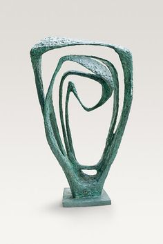 a sculpture is shown in the shape of an abstract figure with wavy lines on it