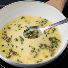 a white bowl filled with soup on top of a stove