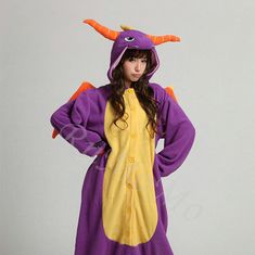 a woman in a purple and yellow costume standing with her hands on her hips,