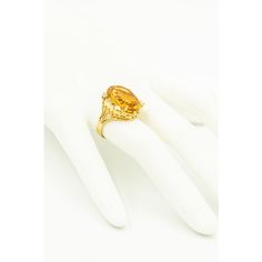 Gorgeous yellow orange color oval faceted citrine accented with 4 prong set approximate size .08 carat diamonds and six 3 prong set approximate .02 carats diamonds. Approximate total weight in diamonds is .44 carats. The sides have open scroll design that resembles a heart.  The citrine measures 13.5mm x 8.5mm.  The ring is 10k yellow gold. US size 8.5.  It can be sized.  The ring measures .76" wide by .86" tall by .36" deep. Oval Yellow Sapphire Diamond Ring Fine Jewelry, Yellow Sapphire Oval Diamond Ring, Classic Yellow Sapphire Oval Rings, Yellow Gold Citrine Oval Diamond Ring, Oval Yellow Topaz Ring In 14k Gold, Yellow Oval Topaz Ring In 14k Gold, Oval Citrine Diamond Ring In Yellow Gold, Oval Yellow Citrine Birthstone Ring, Oval Citrine Birthstone Ring