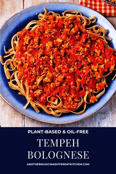 a blue plate topped with spaghetti and sauce