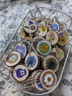 a basket filled with lots of different types of flowers on top of a table cloth