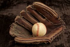 an old baseball mitt with a ball in it