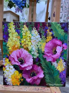 an easel with flowers painted on it