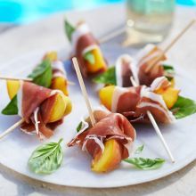 small appetizers are arranged on a plate by the pool, ready to be eaten