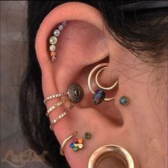 an ear with several different types of piercings on it