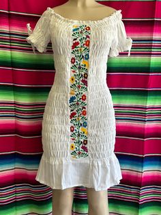 100% Authentic Mexican Dress  This Dress is gorgeous. Once size fit up to Xl Color:White   Size:Large   Note: the floral wall remain the same but the embroidery colors vary on each dress Ebroidery Mexican Dress.Boho Chic Dress Folk Fabric Flowers Mexican Tunic Traditional Embroidery This Dress is perfect for those beach day or any occasion This Dress is meant to provide extreme comfort throughout the day The perfect gift for her Spring Bohemian Embroidered Fitted Dress, White Folk Style Fitted Embroidered Dress, White Folk-style Fitted Embroidered Dress, Multicolor Fitted Bohemian Embroidered Dress, White Bohemian Embroidered Short Sleeve Dress, Fitted Multicolor Embroidered Bohemian Dress, White Fitted Bohemian Embroidered Dress, Casual White Embroidered Dress For Festivals, White Bohemian Embroidered Dress With Short Sleeves