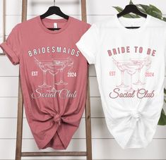 two bridesmaids t - shirts hanging on a wall