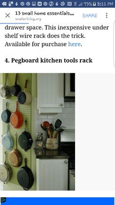 pots and pans are hanging on the pegboard in this kitchen with white cabinets