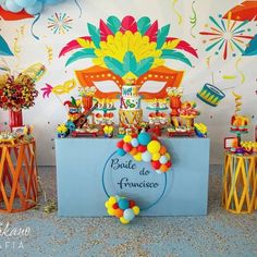 a table with balloons and decorations for a carnival themed birthday or baby's first birthday