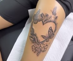 a woman laying down with a tattoo on her leg