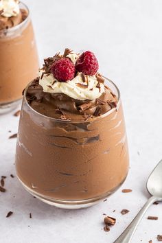 two desserts with chocolate pudding and raspberries on top