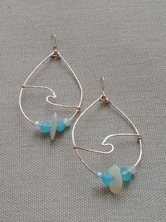 ¨¨oºૐºooºૐºooºૐºooºૐºo These beautiful ocean wave earrings were created with beautiful glass beads in 2 shades of ocean blues and mother of pearl natural shells. The wave focal is lovingly hand crafted and wire wrapped to the tear drop shaped hoops. Can be created with sterling silver, 14k gold filled or copper wire. Nickel Free Teardrop Beaded Earrings For Beach, Nickel-free Teardrop Beaded Earrings For Beach, Teardrop Hoop Earrings With Ear Wire For Beach, Beach Wire Wrapped Teardrop Earrings, Beach Teardrop Wire Wrapped Earrings, Beach Teardrop Beaded Earrings, Handmade Teardrop Earrings For Beach, Upper Arm Cuffs, Beautiful Arms