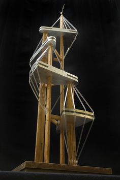 a tall wooden structure with metal straps on it's sides and an object in the background