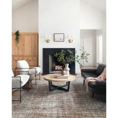 a living room filled with furniture and a fire place in the middle of a room