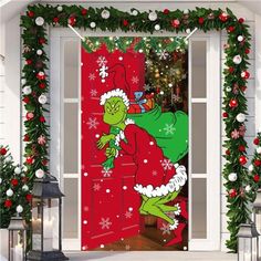 the grinch door cover is decorated with christmas garlands and lights, as well as decorations