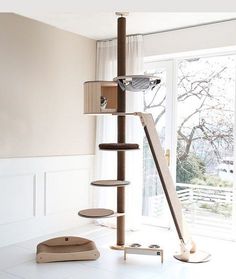 a cat tree in the corner of a room